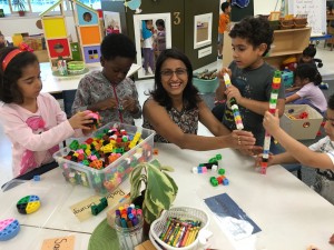 Making towers with Mrs. Goyal and realizing 20 block towers are BIGGER than 16 block towers!